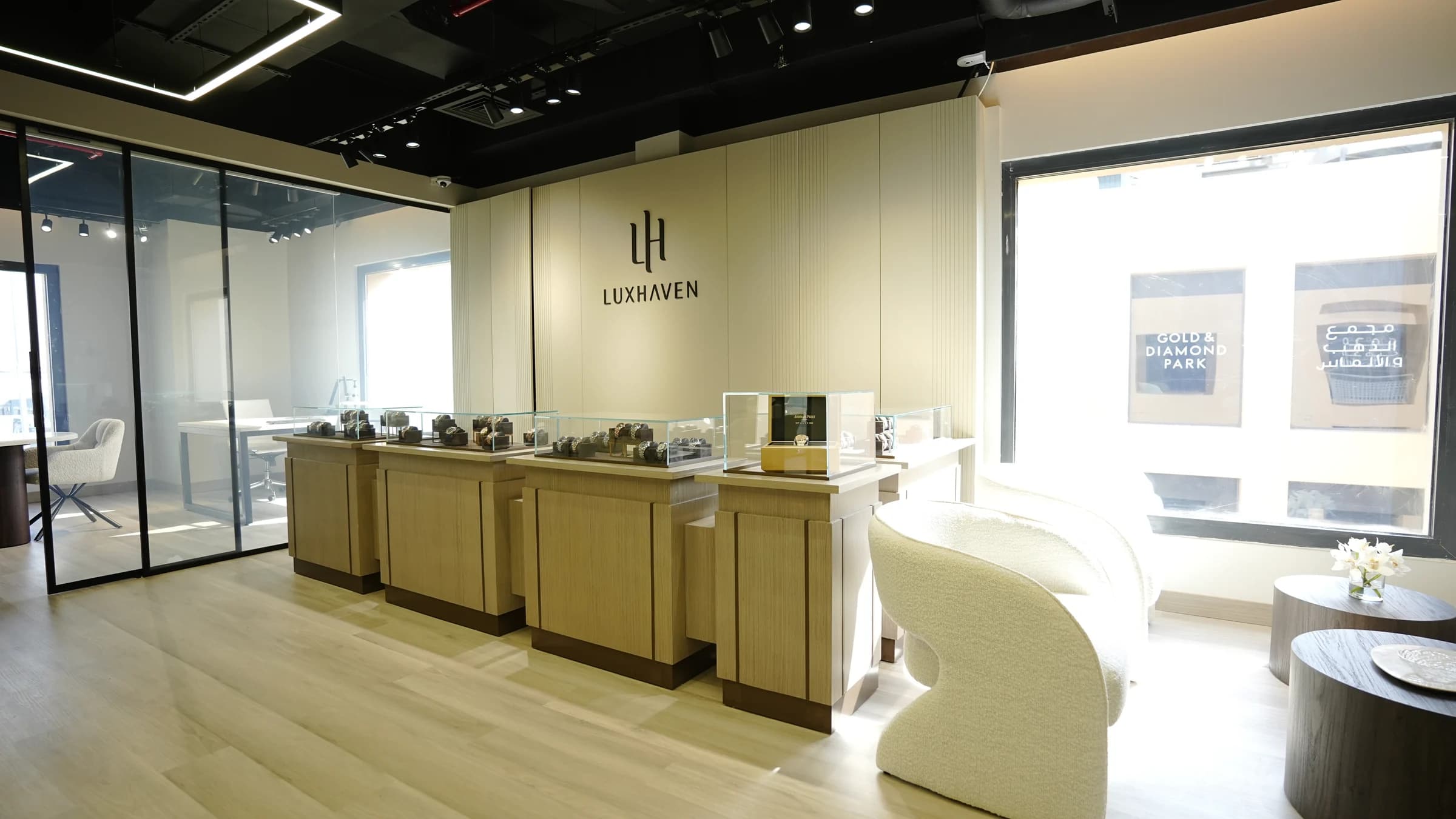 Watch display cabinets and the Luxhaven logo inside our Gold & Diamond Park showroom